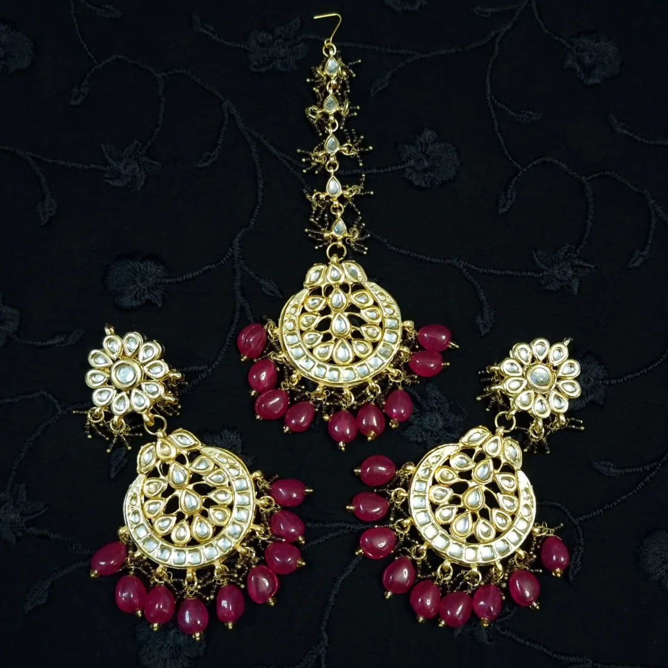 Bridal kundan piece is four layered set with dangling emeralds to match your festive.