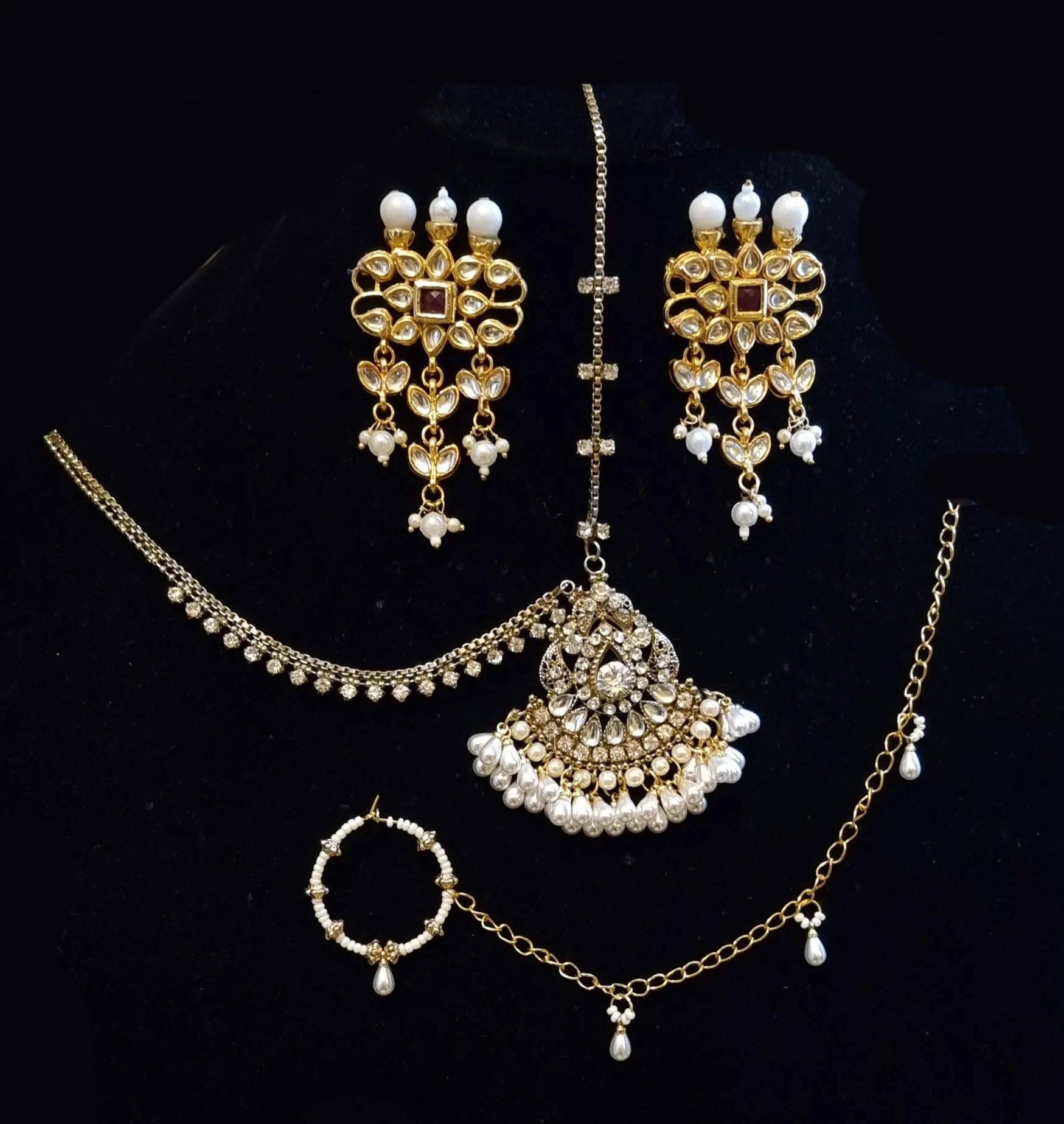 Maharaani kundan choker with 7 layered kundan malaa and earrings with nath and maang tikka.